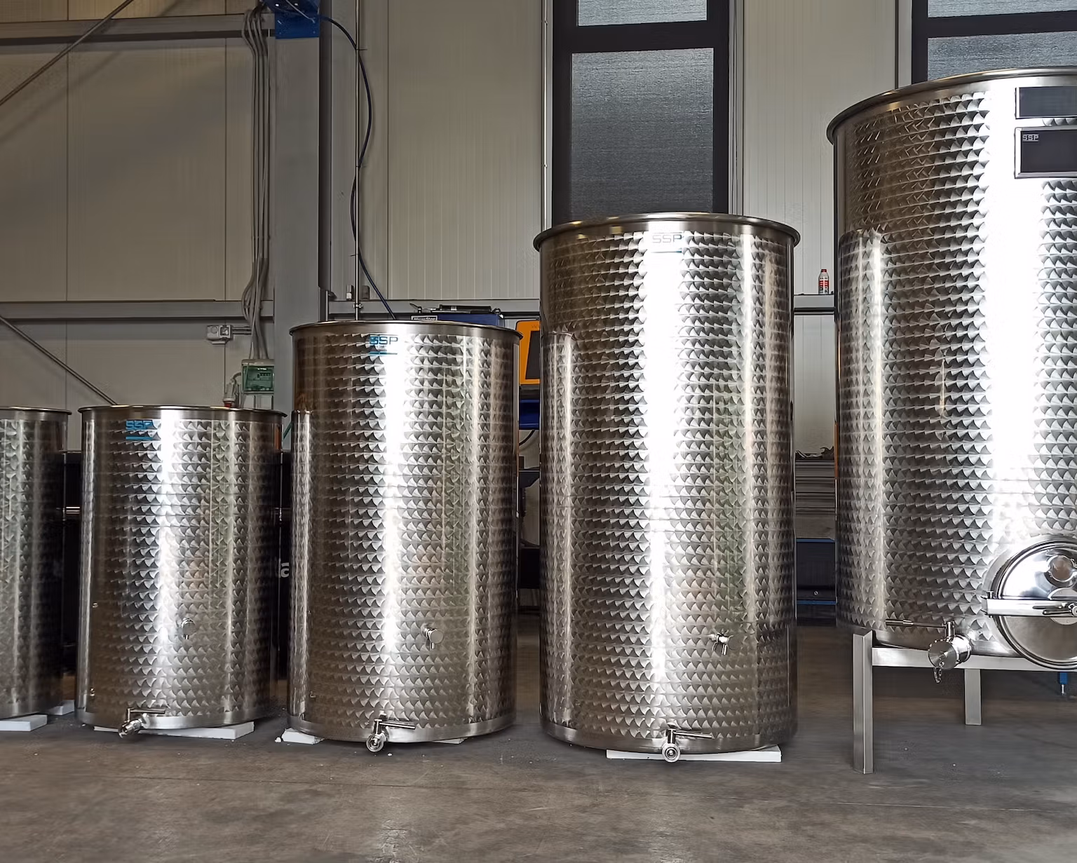 line of different capacity cylindrical tanks