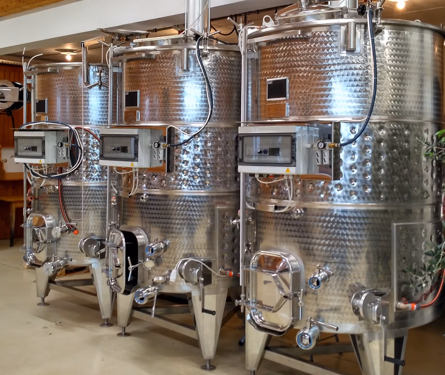 stainless steel products - image of three variable capacity wine tanks in situ in clients cellar