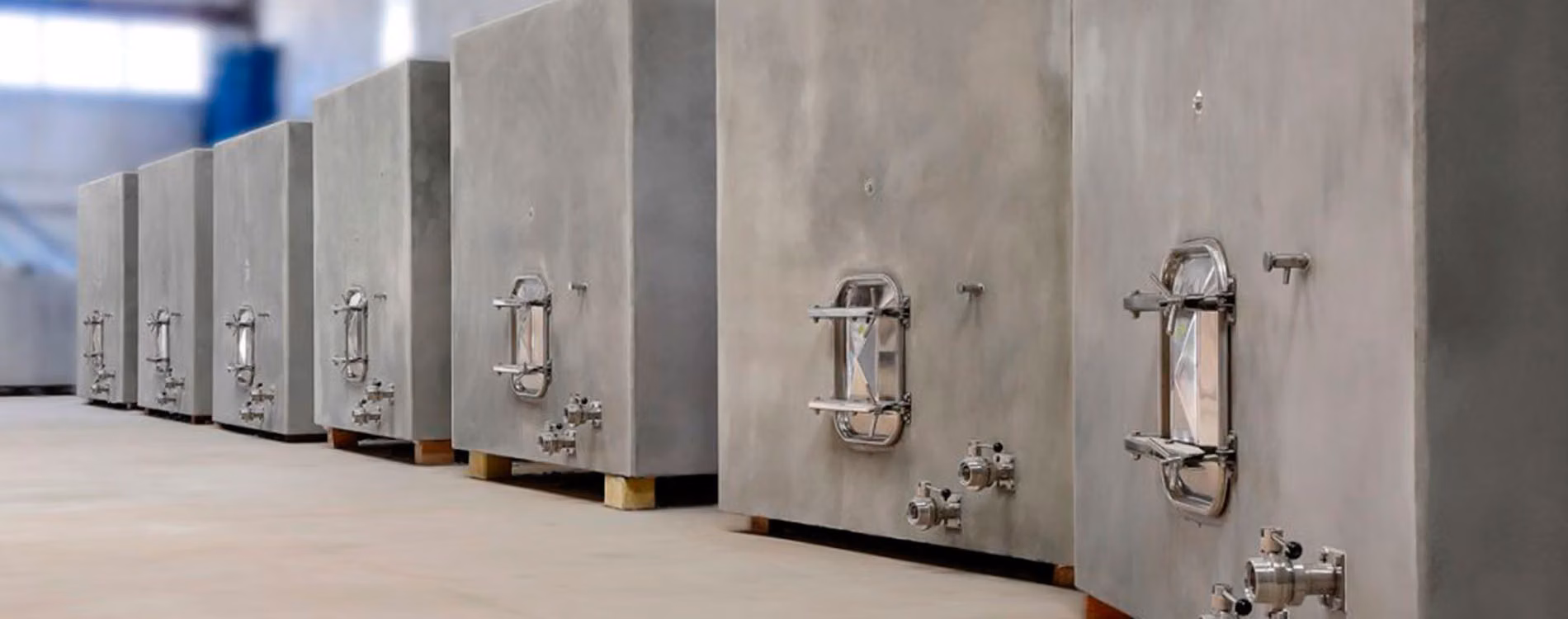 concrete wine tanks - SERIE concrete tanks lined up in a winery