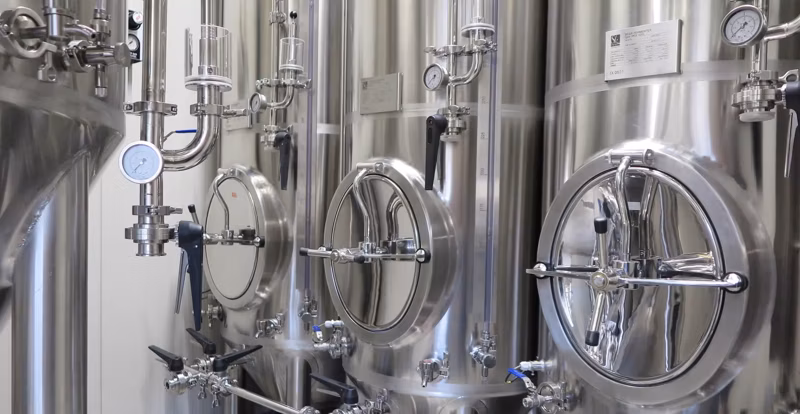 small array of conical fermenters with front manways and temperature readout